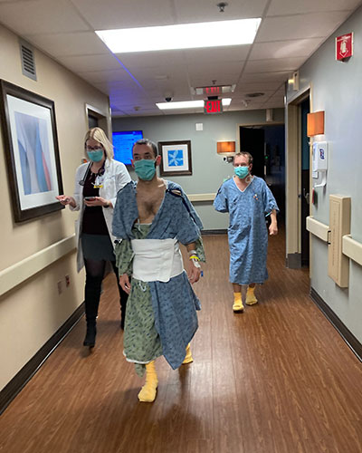 Matt Maddux walks through the hallways of the Transplant Institute at Research Medical Center following nephrectomy surgery.