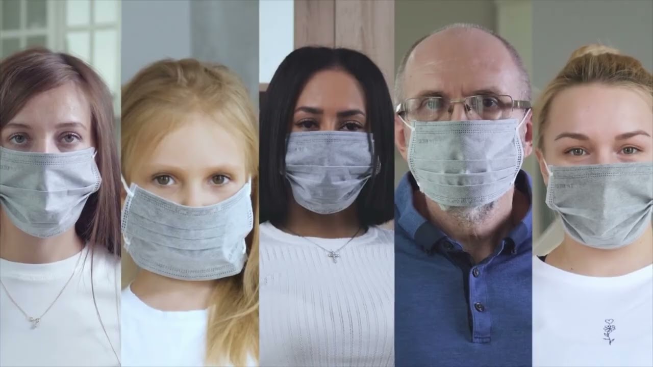 Five individuals wearing PPE masks.