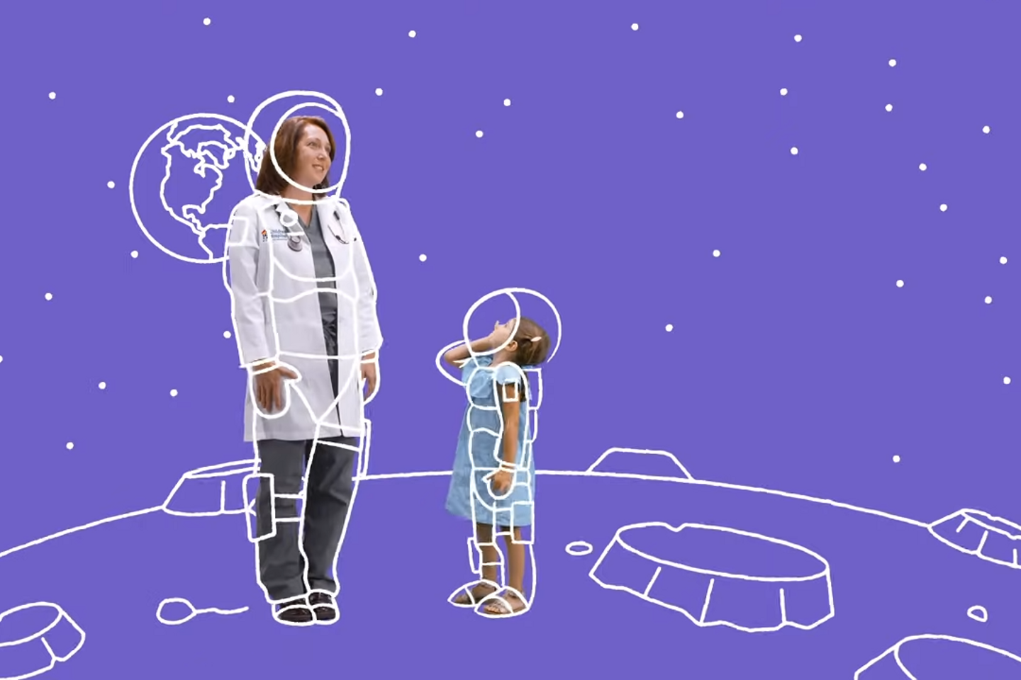 A doctor and a child pretend to be astronauts on the moon.