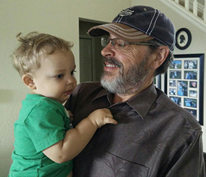 Stroke survivor Gary Brown holding his grandson.