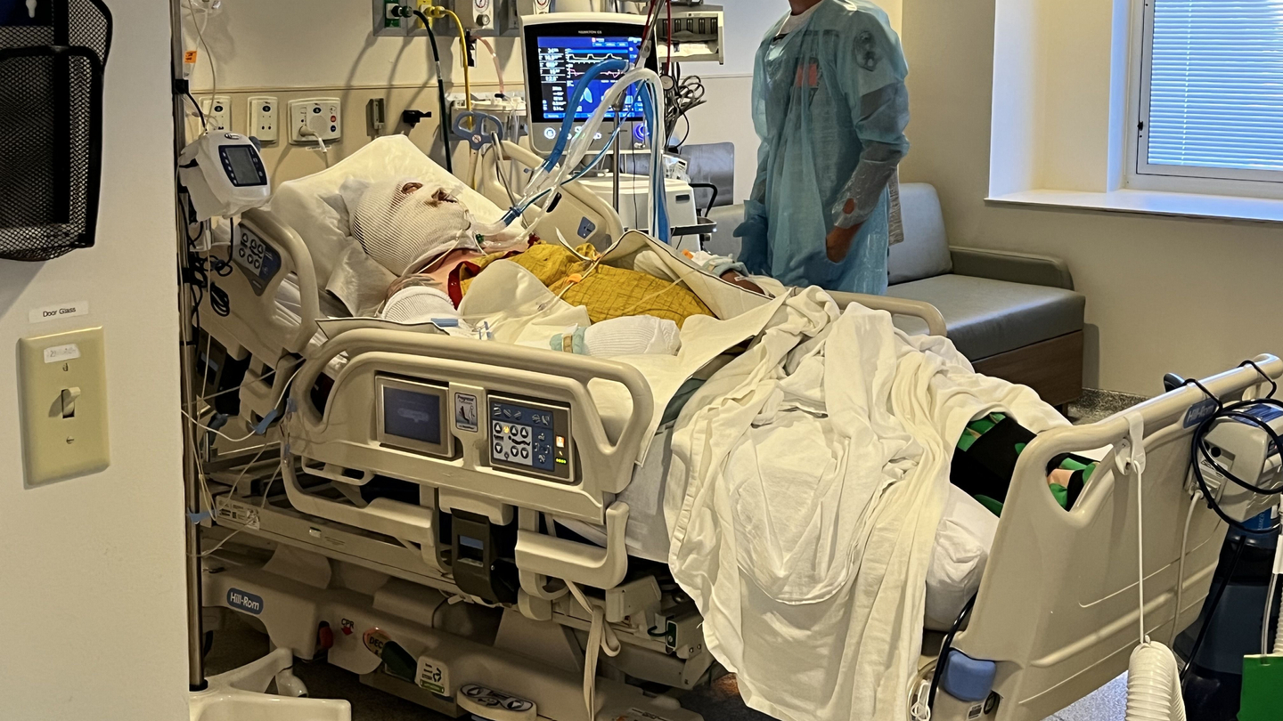 Ryan Keen in bed in hospital room.