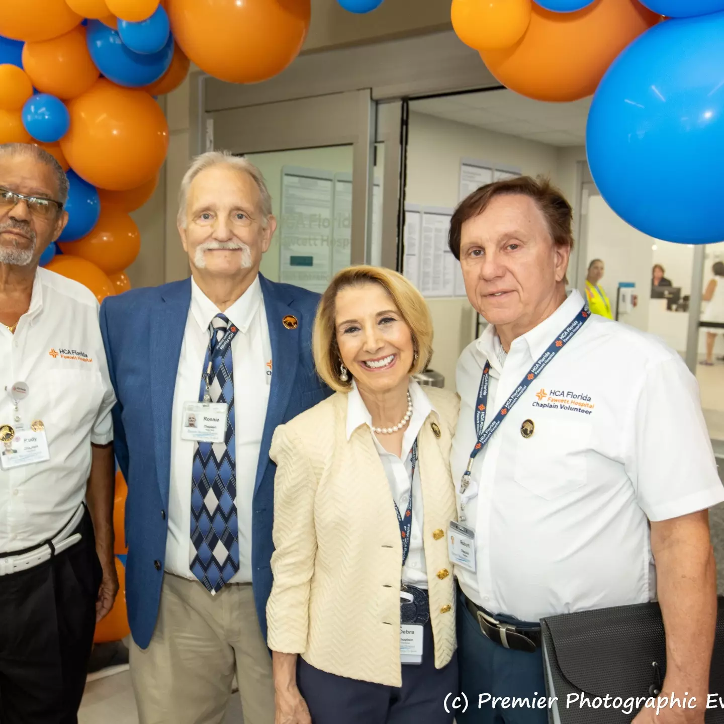 Three gentlemen and a lady attend the ribbon cutting ceremony.