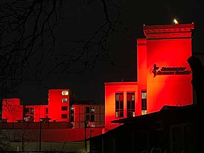 Hospital building bathed in red light to signify Heart Month