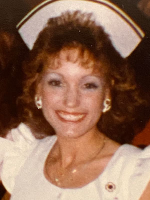 A younger Marilyn Mariani wears a nurse hat and white shirt with short ruffled sleeves