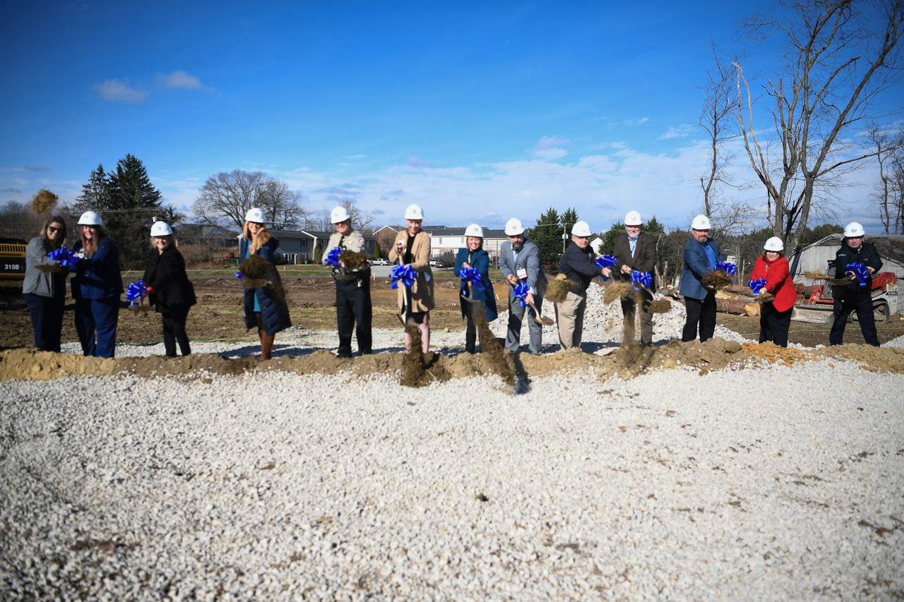Hospital staff pose with hardhats and shovels.
