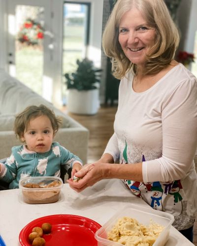 Karla smiles while cooking with her grandchild.
