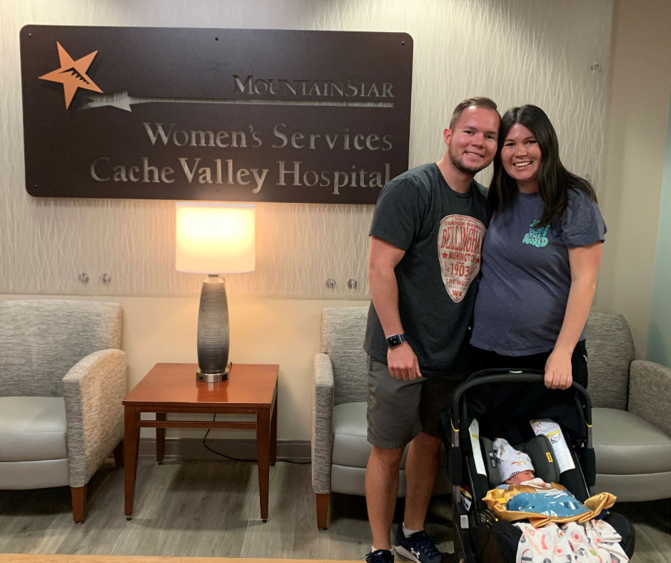 Haeli, Carlyn, and baby Spencer standing in front of the Women's Services Cache Valley Hospital sign.