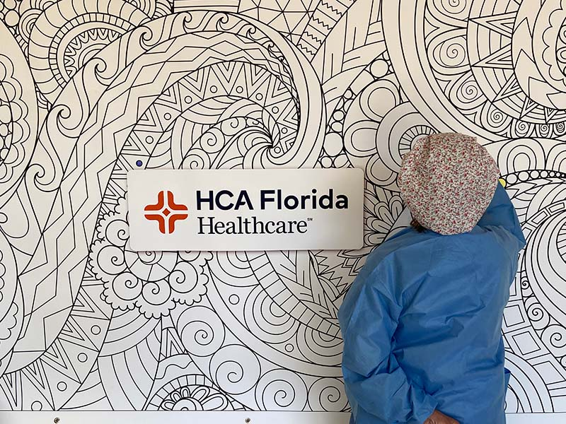 HCA Healthcare staff filling in HCA Florida Healthcare coloring mural