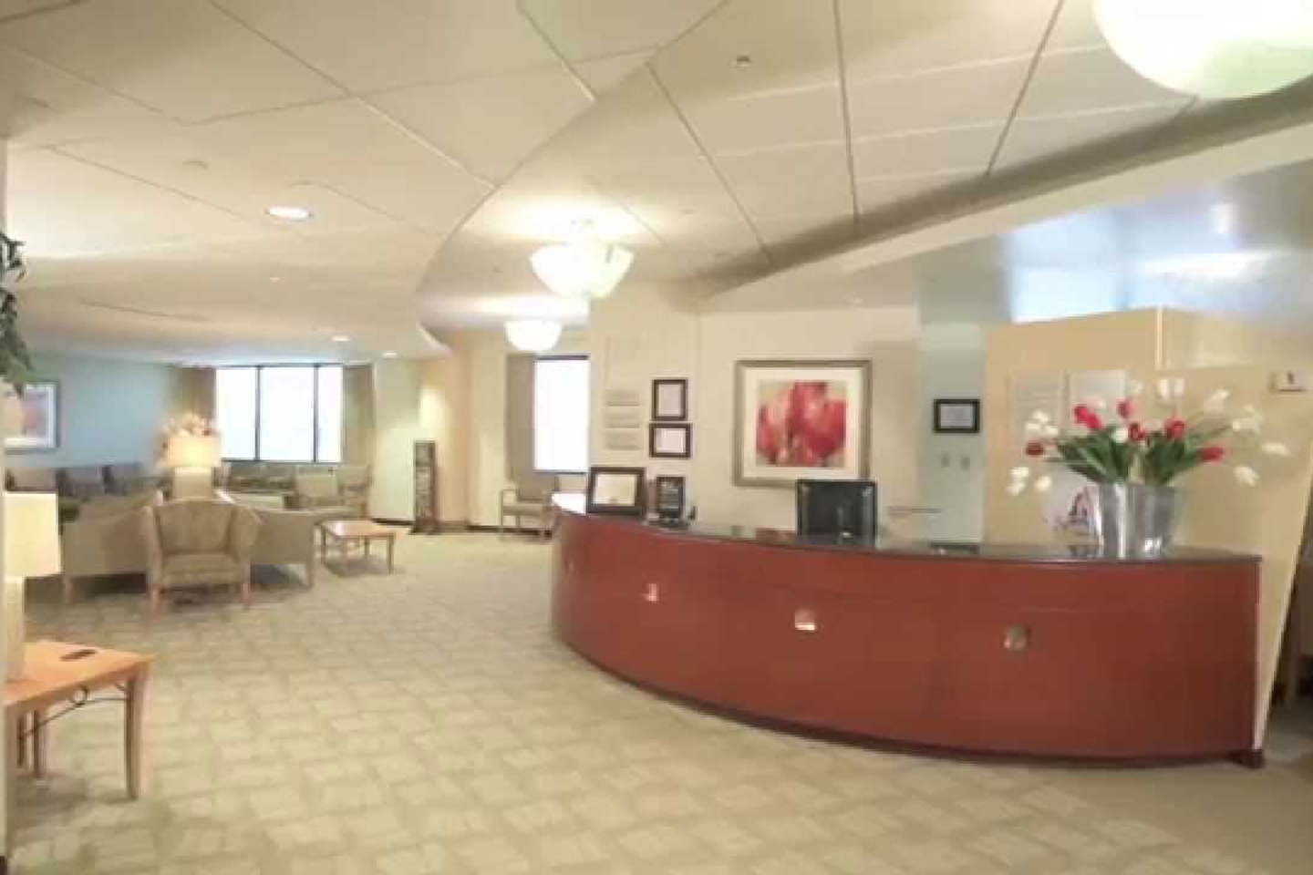 Interior lobby of the Reston Hospital Women's Imaging Center, with a nurses station and a patient waiting room with wingback chairs.