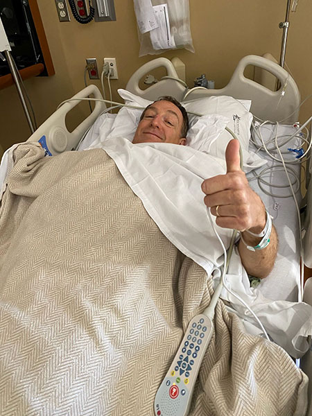 Bud Chew giving a thumbs up from his hospital bed.