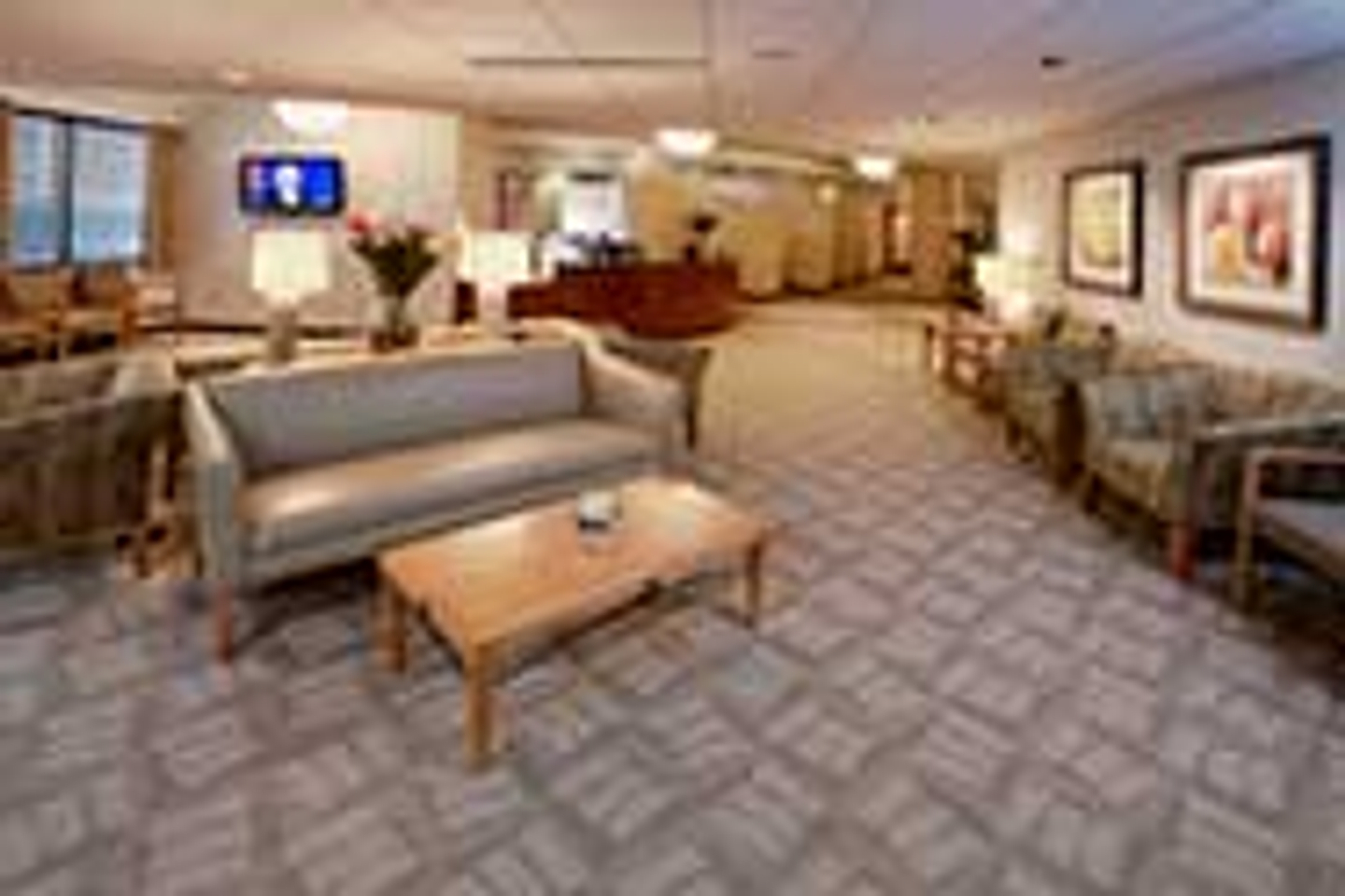 Interview lobby of Reston Hospital Center, showing a patient waiting room with chairs and tables, and a nurses station.