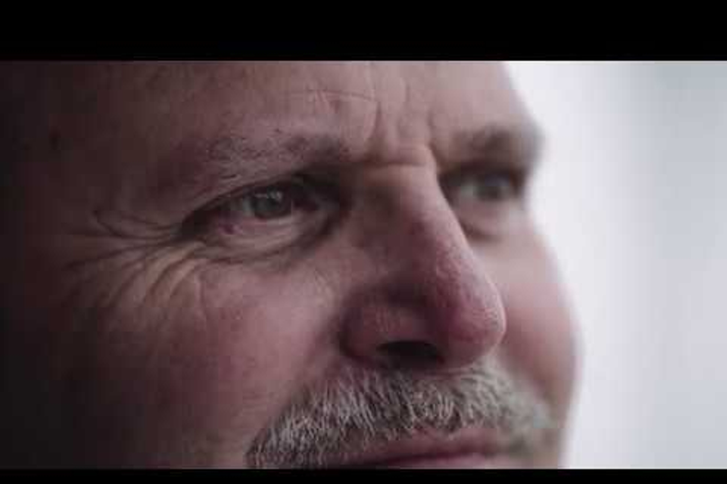 A closeup of Paul's face with soft light illuminating from right to left.