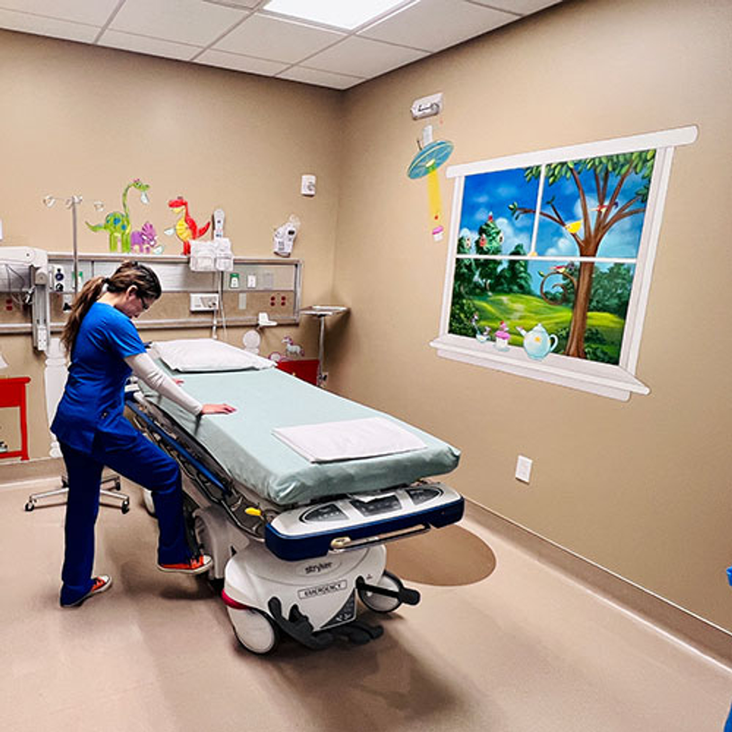 Jennifer Madrona, BSN, RN preparing a pediatric specialty room.