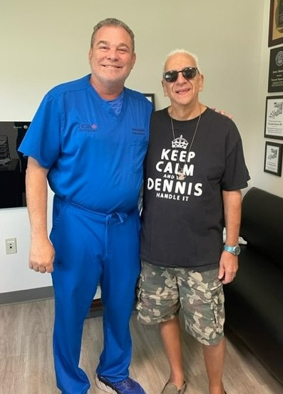 Dennis Fasono after weight loss surgery, posing with his physician