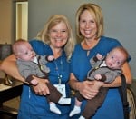 Registered nurses Heather Despard and Cynthia Bonieracine holding two babies.