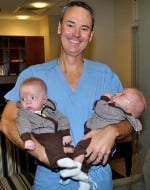 Dr. Forschner holding the Santala twins.