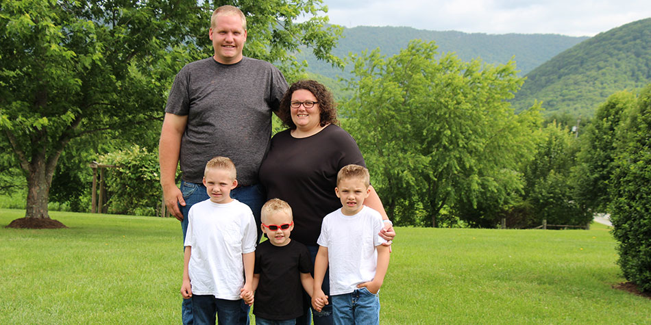 Heather Umberger poses with family in a nature setting, pre-surgery