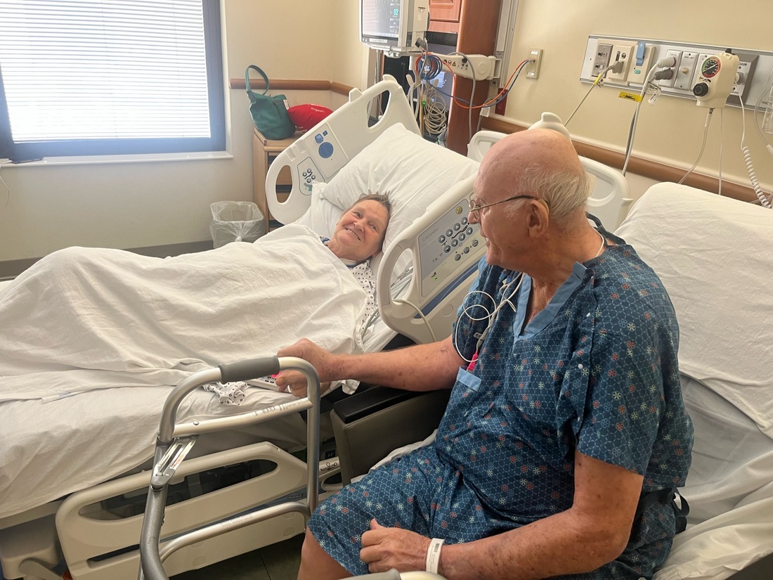 Phil and Margaret Vaske sitting beside each other in hospital room