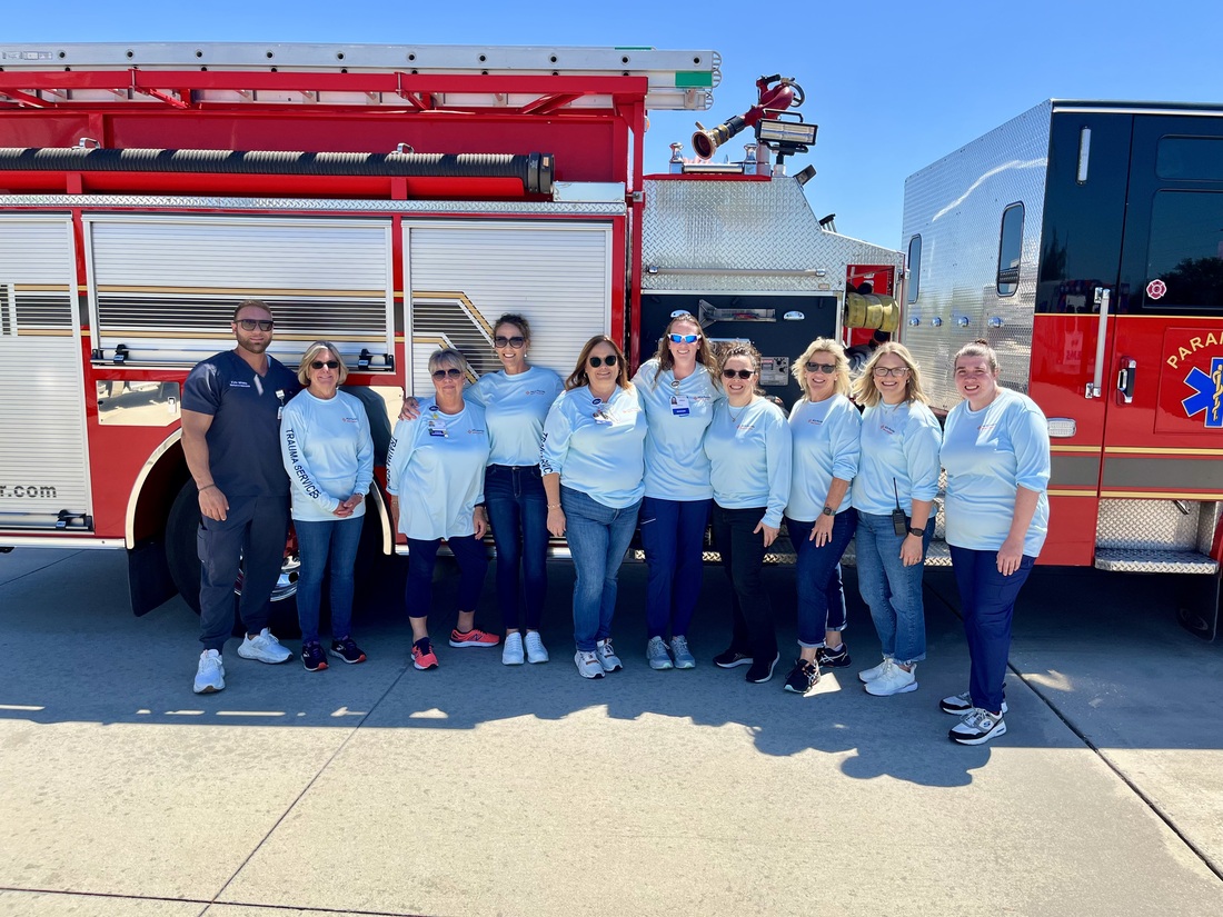 HCA Florida Blake Hospital hosted EMS Field Day - group photo outside in front of fire truck