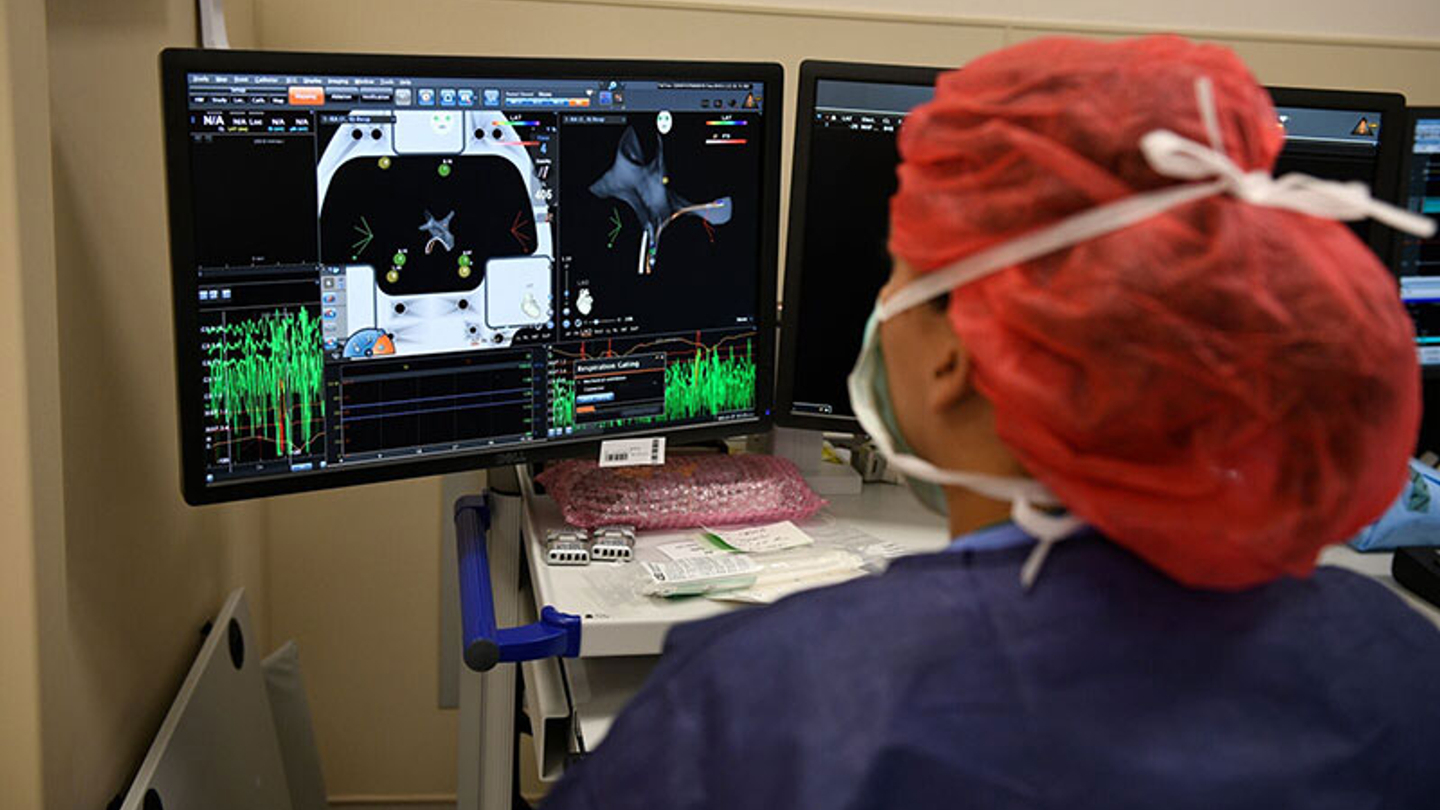 technician looking at electrophysiology output on screen