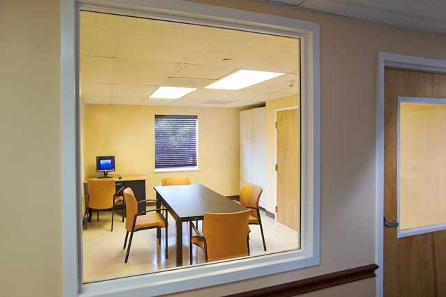 Looking into the study room window from the hallway at Reflections Eating Disorder Treatment Center
