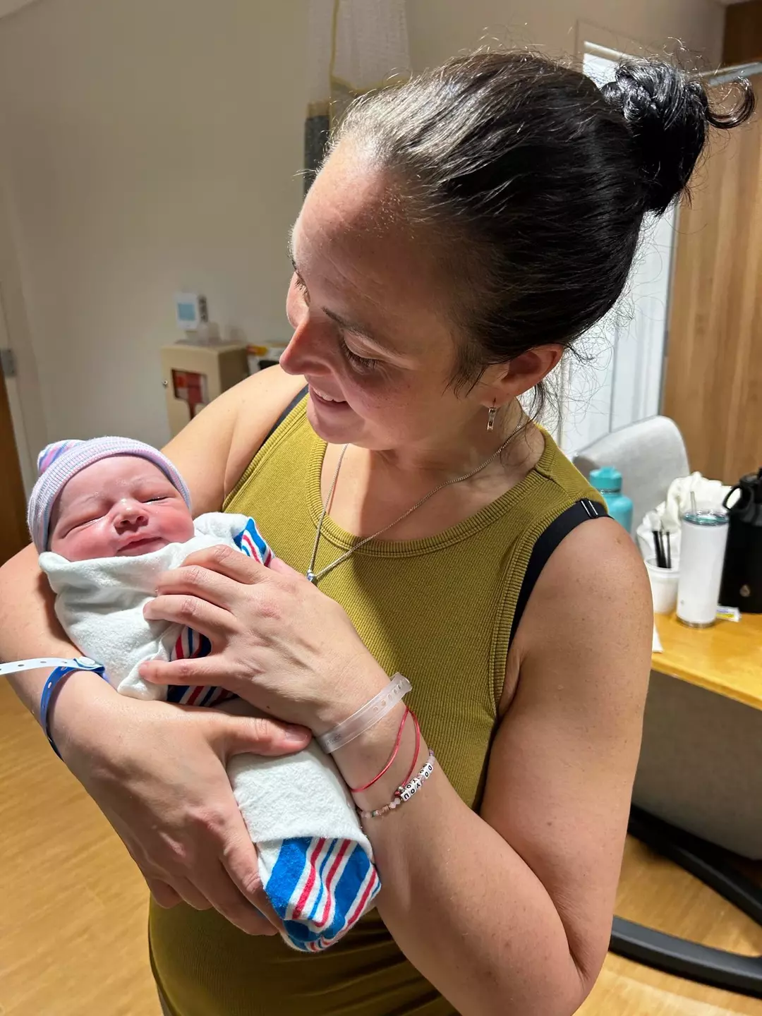 Jessey Bowers holding her infant grandson