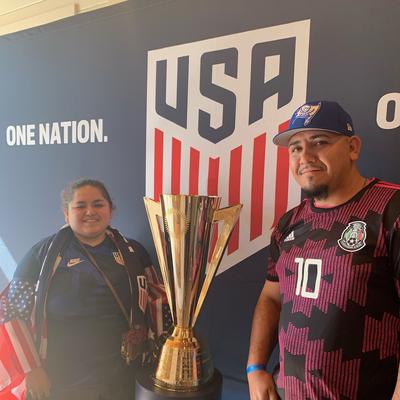 Jose and Feve Cornado pose with soccer trophy.
