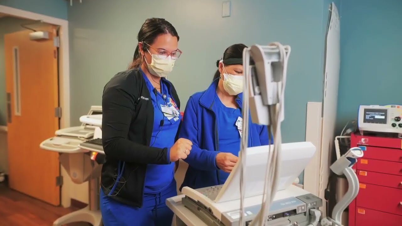 Two GME students work with medical machinery in the hospital.