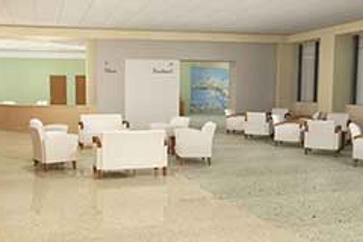Interior view of the Reston Hospital Center main lobby, with a large open room for patient seating and a customer service desk towards the back of the room.