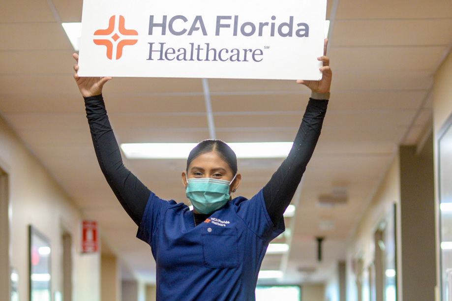 Physicians and colleagues celebrate the new HCA Florida Healthcare logo