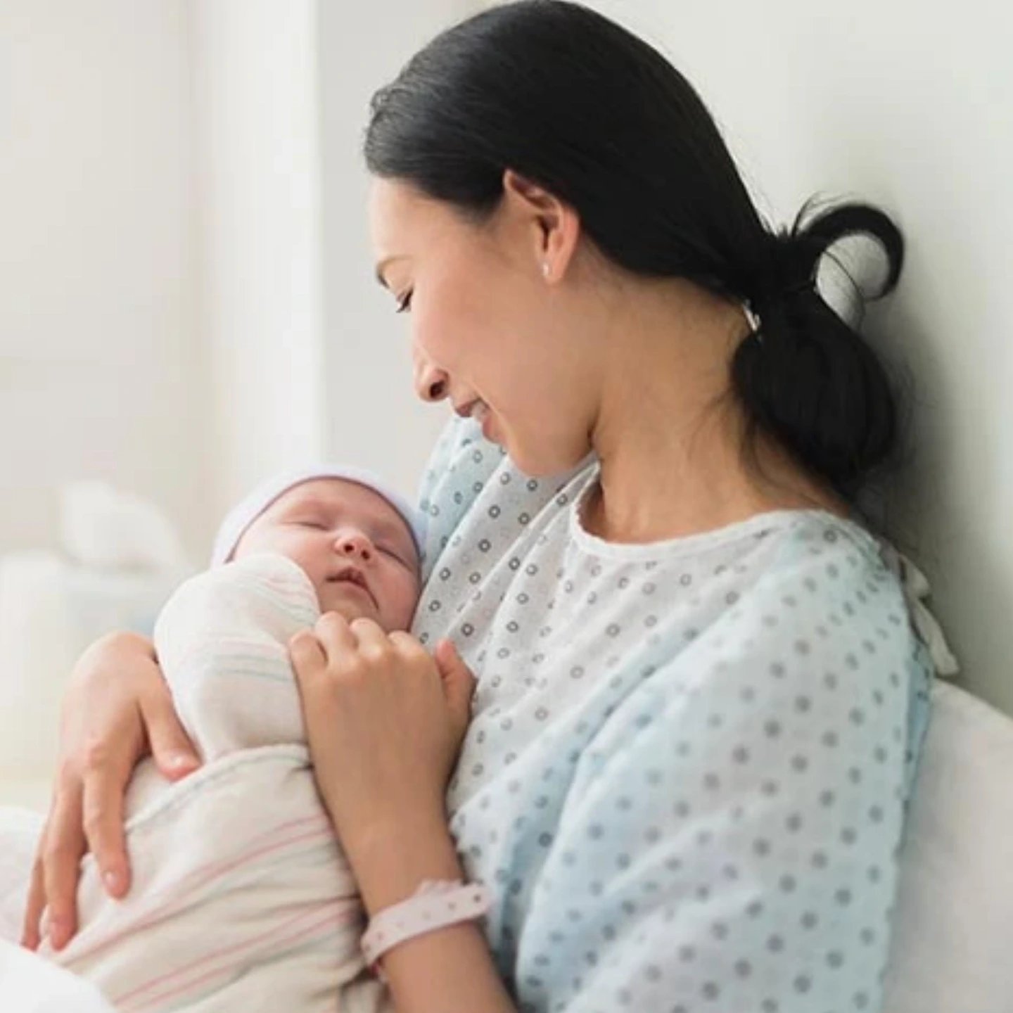 A mother holding a newborn baby.