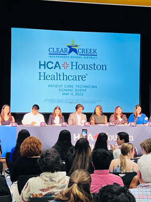 Clear Creek ISD students prepare to sign HCA Houston Healthcare job offer letters.