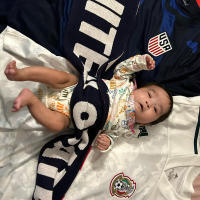 Baby Amaris Cornado wrapped in USA soccer scarf.