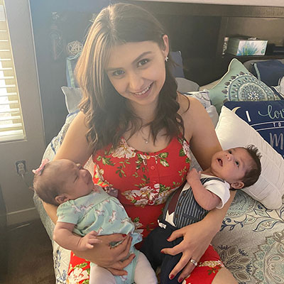 Melisa Villegas joyfully holding her twins babies.