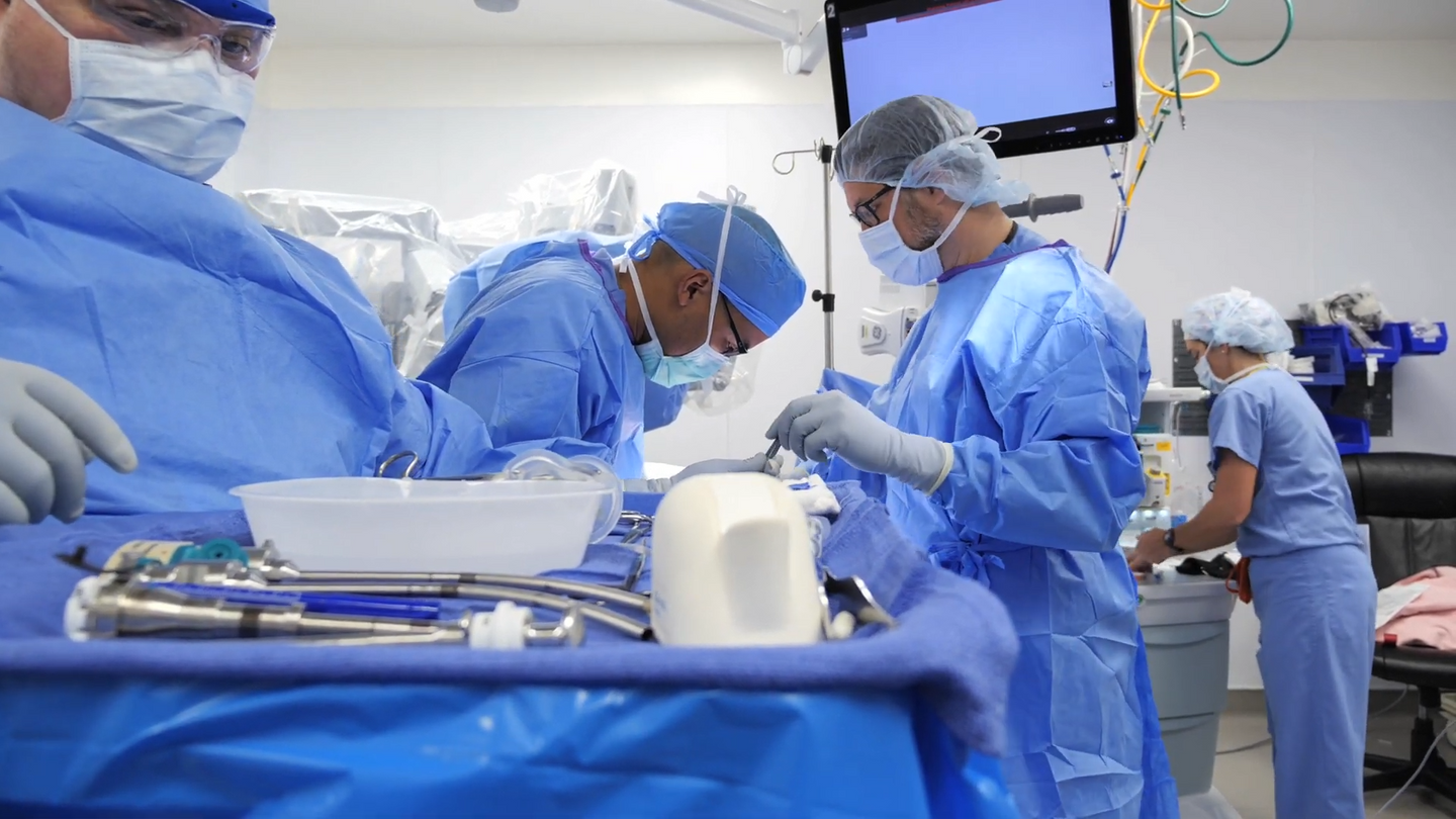 A robotic surgery team in the operating room, performing a surgical procedure on a patient.
